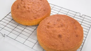 A freshly baked cake cooling on a wire rack.